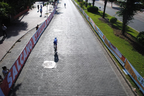 Biking in the sun, on modern cobbles