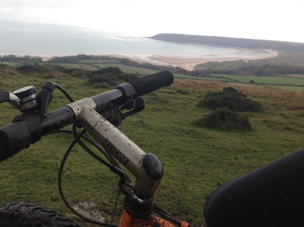 Mountain biking with views of Oxwich Bay.